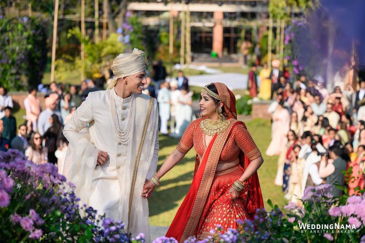 Aanchal and Shaswat walking hand in hand through their guests
