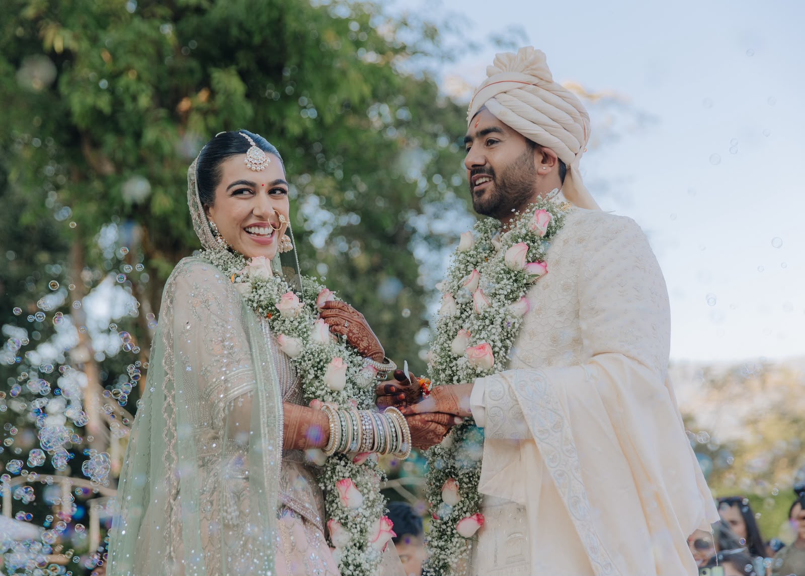 Ankshita and Rohit in garlands, surrounded by bubbles