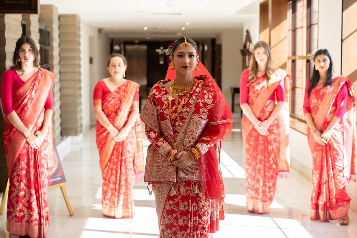Anushka in her red saree with her bridesmaids at the Soaltee