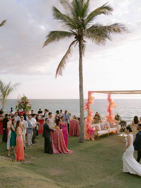 Guests at a cliffside sundowner by the sea