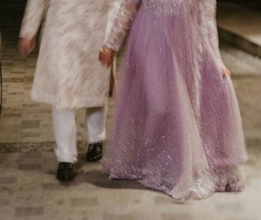 Salsabil in a sparkling lilac gown walking beside her husband