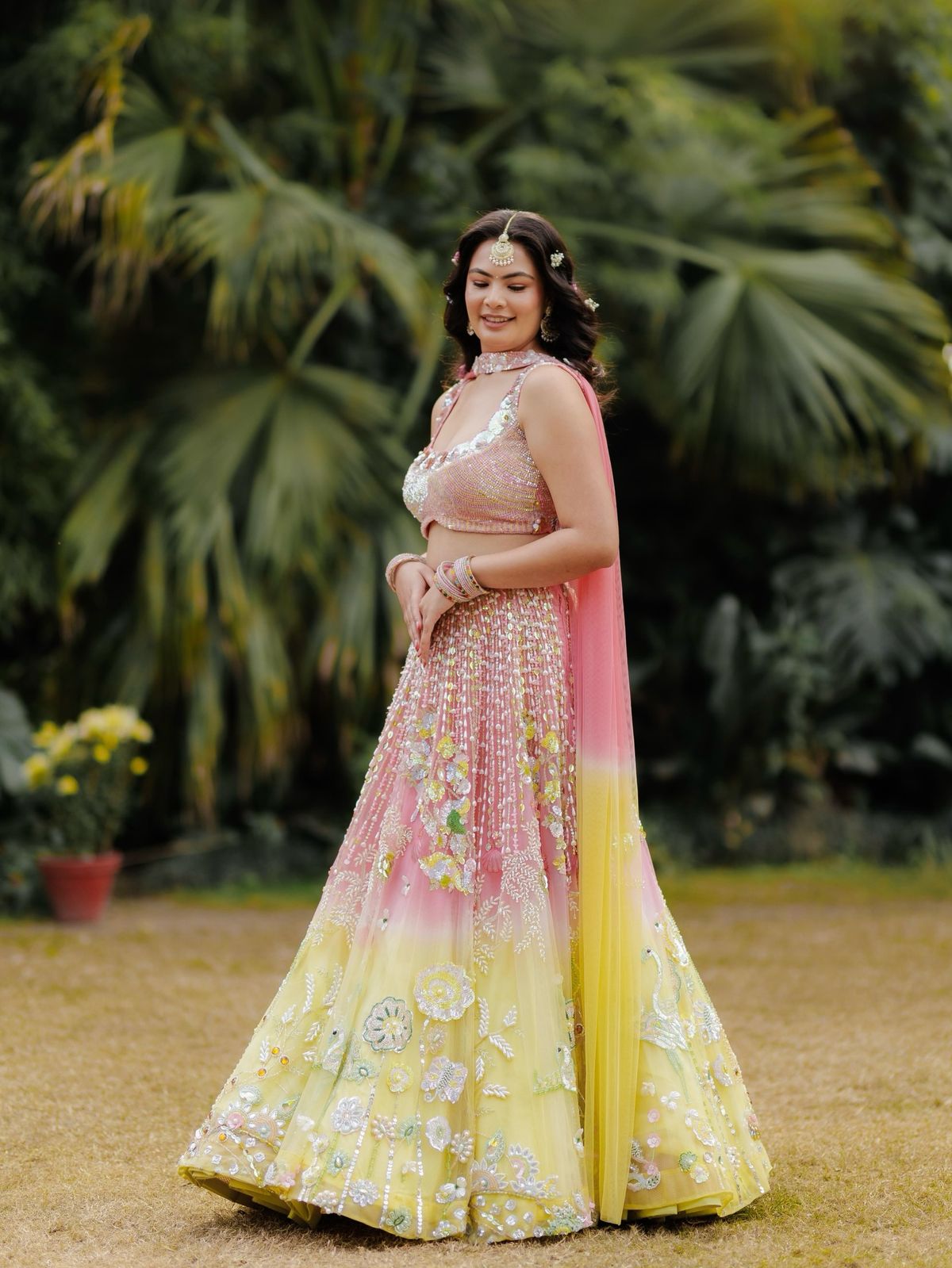 Ushma in a pink and yellow lehenga at her mehndi