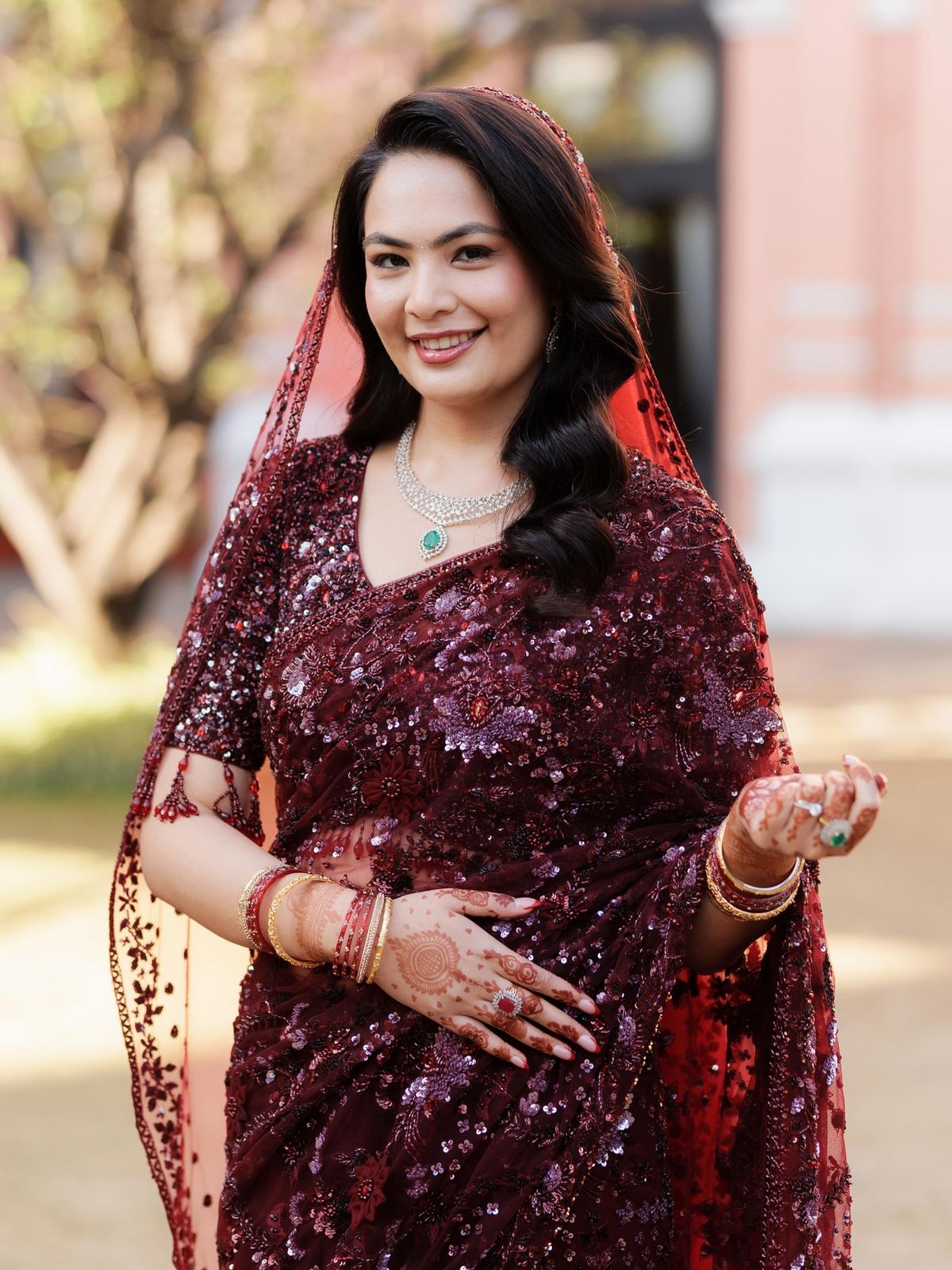 Ushma in a burgundy saree at her reception